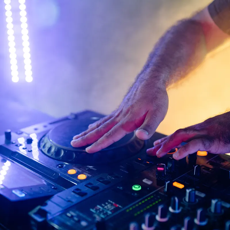 noteworthy djs hands on turn table at a wedding